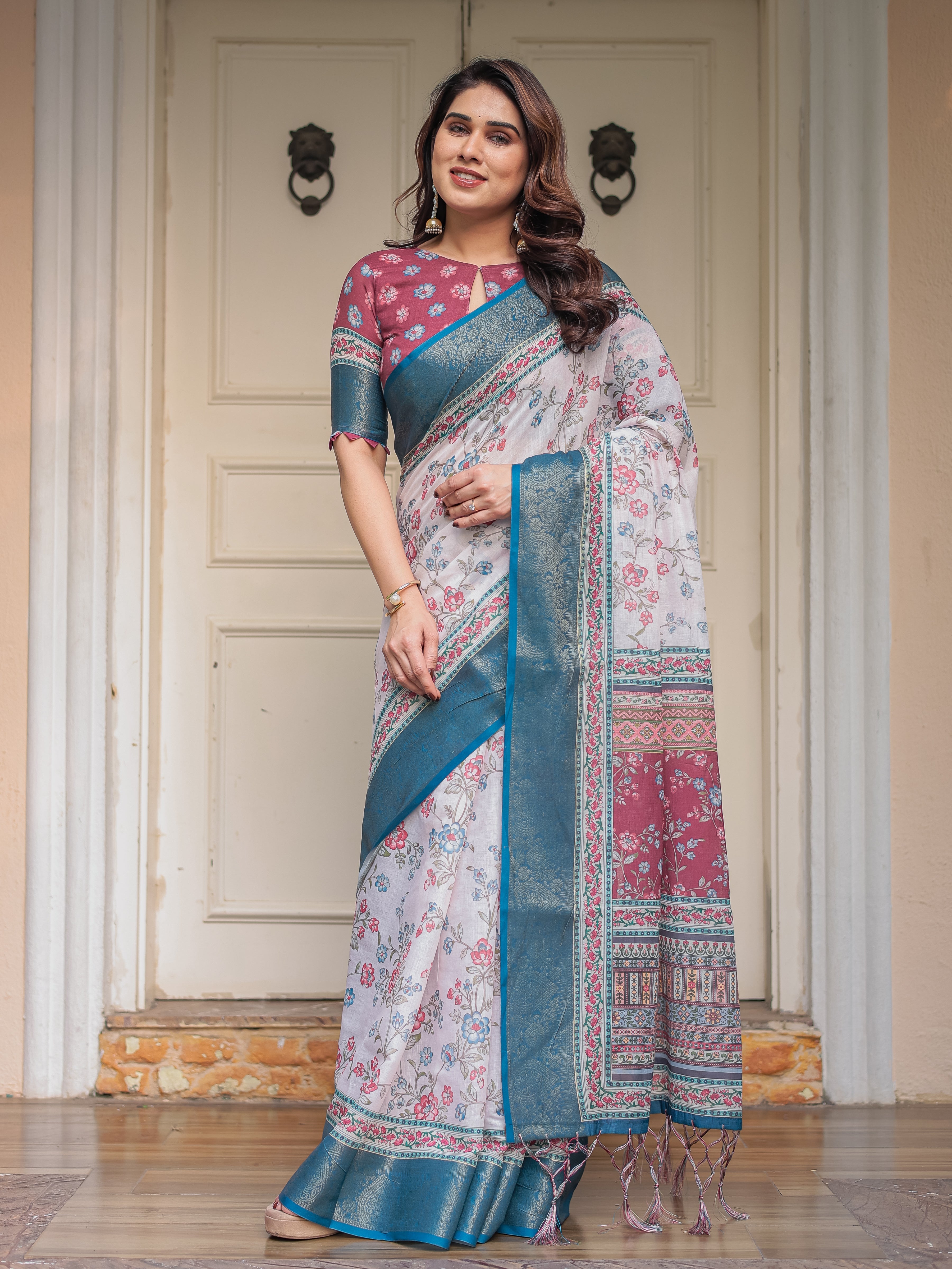 Ivory Floral Printed Saree with Rose Pink & Teal Blue Zari Border & Tassels – Elegant Festive Ethnic Wear