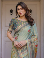 Mint Green Folk Printed Handloom Cotton Saree with Village Scene Panel Pallu, Ornamental Border & Tassels – Traditional Ethnic Wear