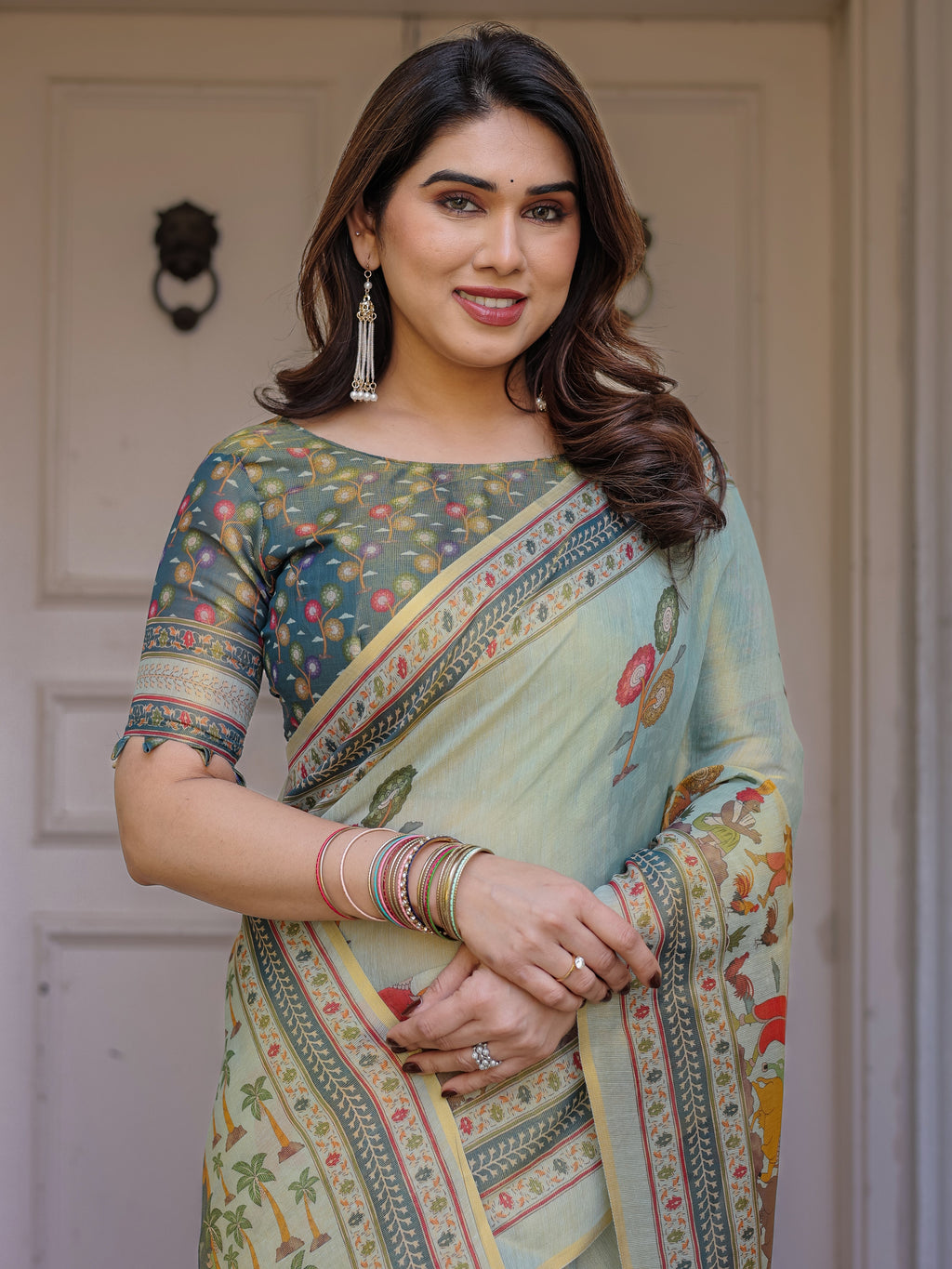 Mint Green Folk Printed Handloom Cotton Saree with Village Scene Panel Pallu, Ornamental Border & Tassels – Traditional Ethnic Wear